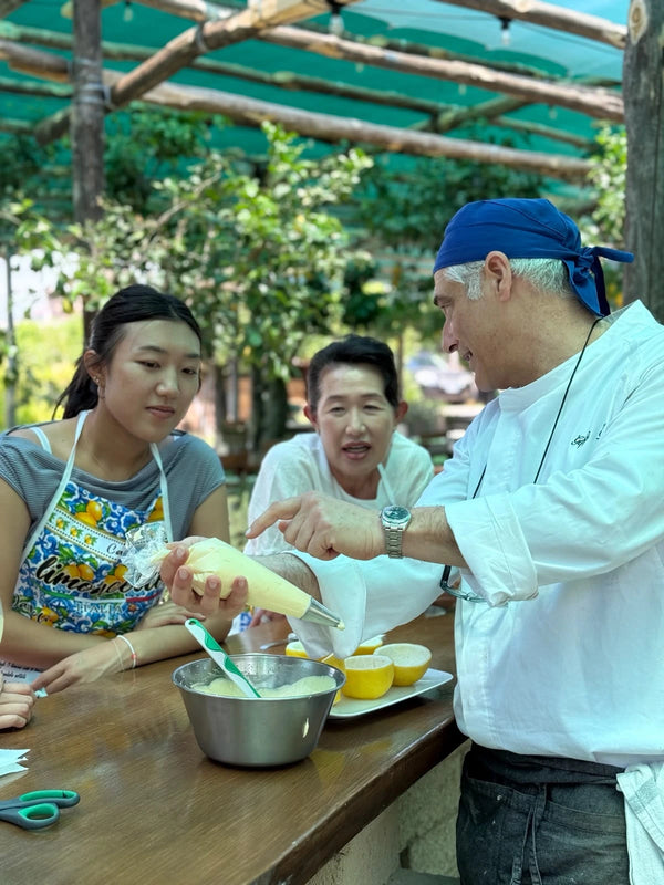 Participants enjoying a gluten free cooking class with a professional chef in Sorrento, Italy.