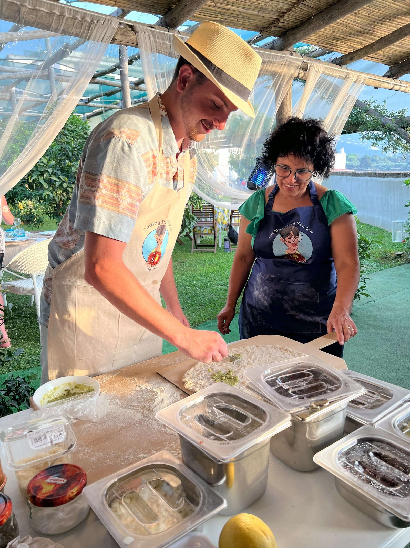 Participants enjoying the Pizza Making Class in a lemon grove, surrounded by fresh ingredients and a picturesque setting.