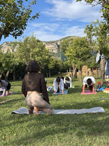 Participants in Sorrento Pilates Class practicing outdoors in a lemon grove with scenic hills in the background.