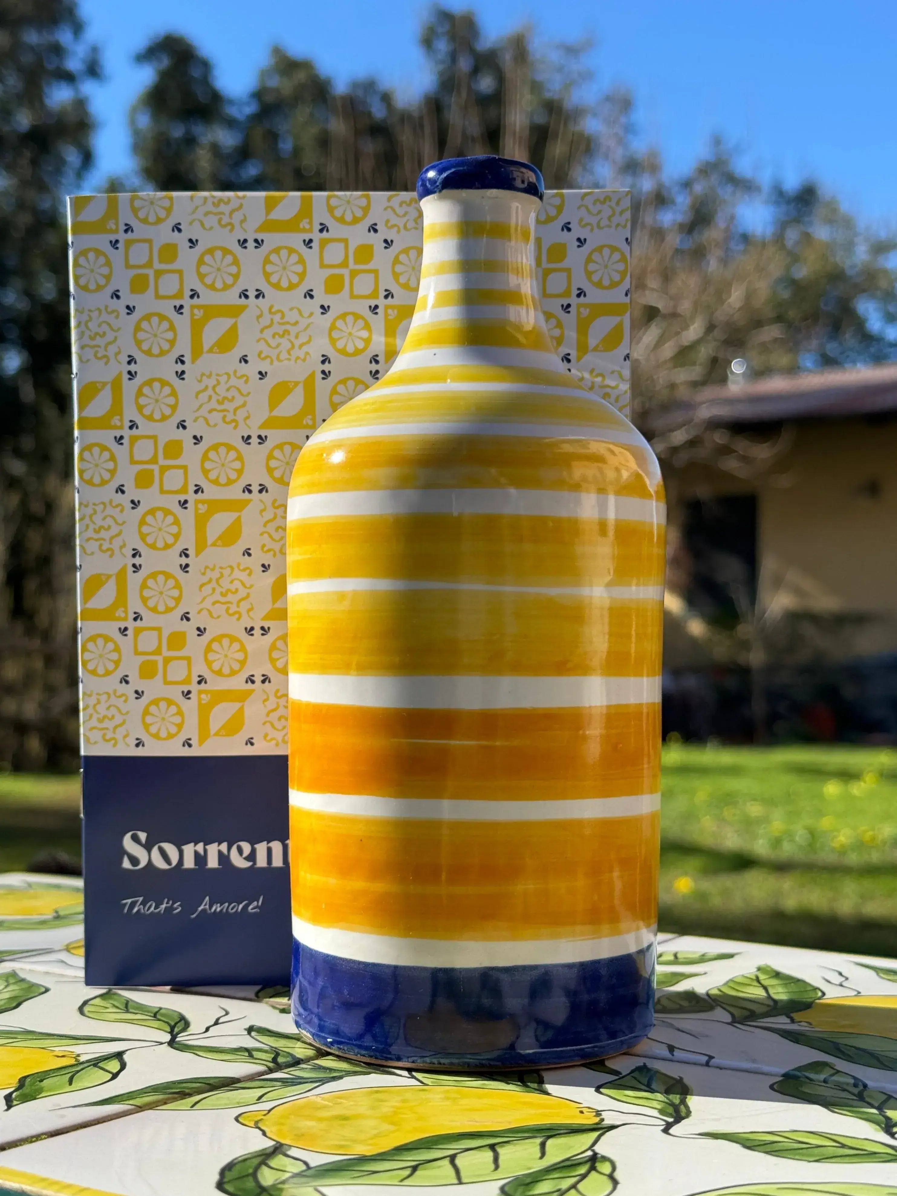 Vibrant Limoncello ceramic bottle with Sorrento kit box, perfect for crafting homemade liqueur with IGP Sorrento Lemons.